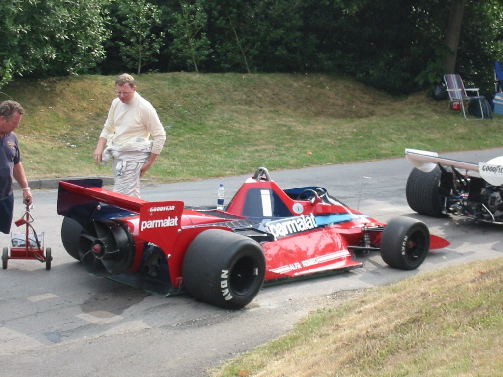 The Brabham BT46B at Goodwood, seen from the rear quarter where the fan is plainly visible behind the gearbox. Gordon Murray's car extracted air from a skirt-sealed box under the floor, which made its downforce independent of road speed — the one thing a wing can never do.