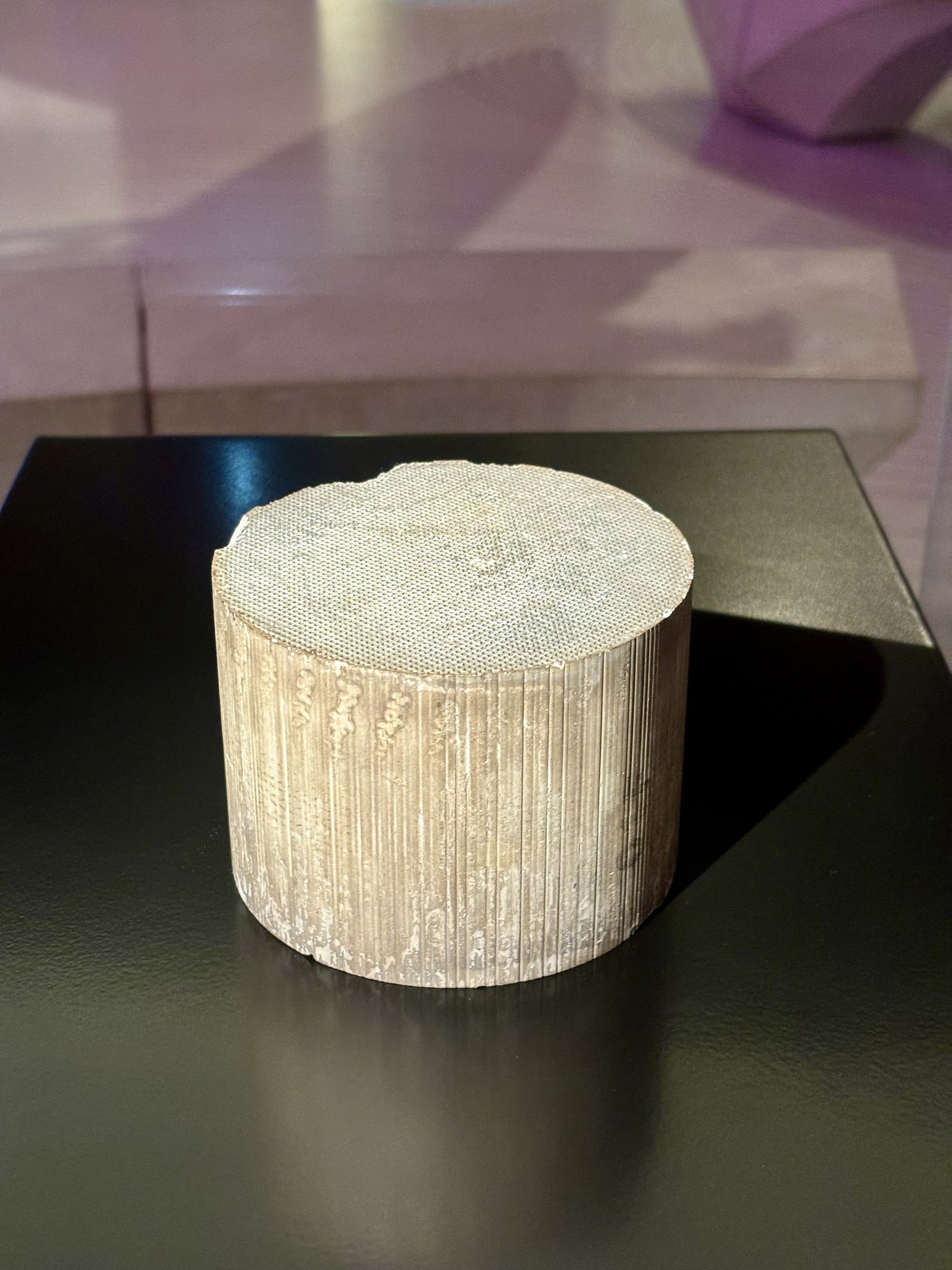 The monolith on its own, out of its can: a honeycomb cylinder of thin extruded walls, on display at the Science Museum in London. The washcoat and precious metals live on those wall surfaces, not in the structure itself.