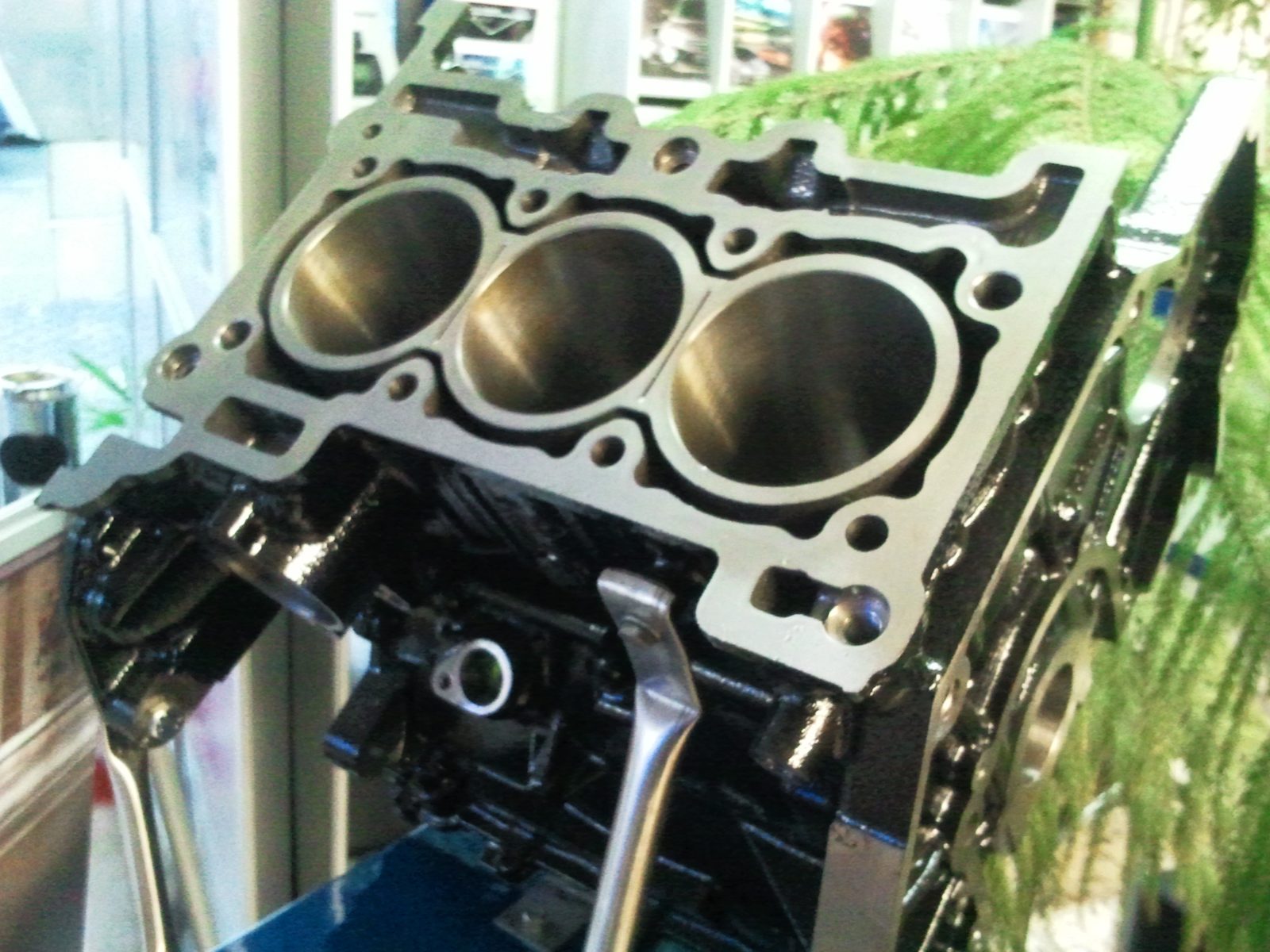 A cutaway display block from Ford's 1.0-liter three-cylinder EcoBoost. In the running engine, the timing belt lives inside the crankcase, submerged in the same oil that lubricates the bearings.
