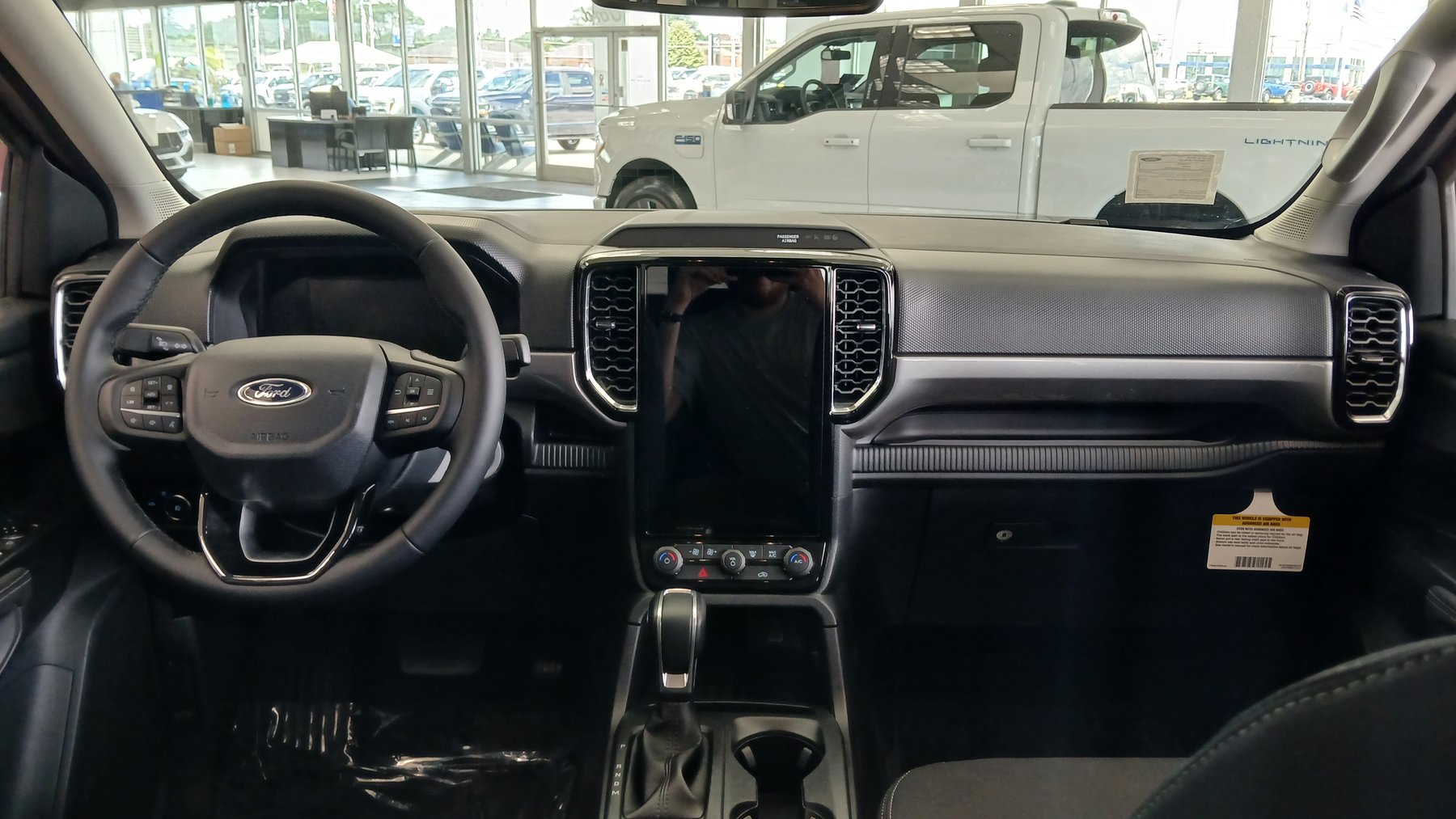 The current Ranger's dashboard, built around a portrait center stack screen. Ford's filing says 11,405 trucks left Michigan Assembly with a 10.1-inch unit whose circuit board carries a suspect capacitor.