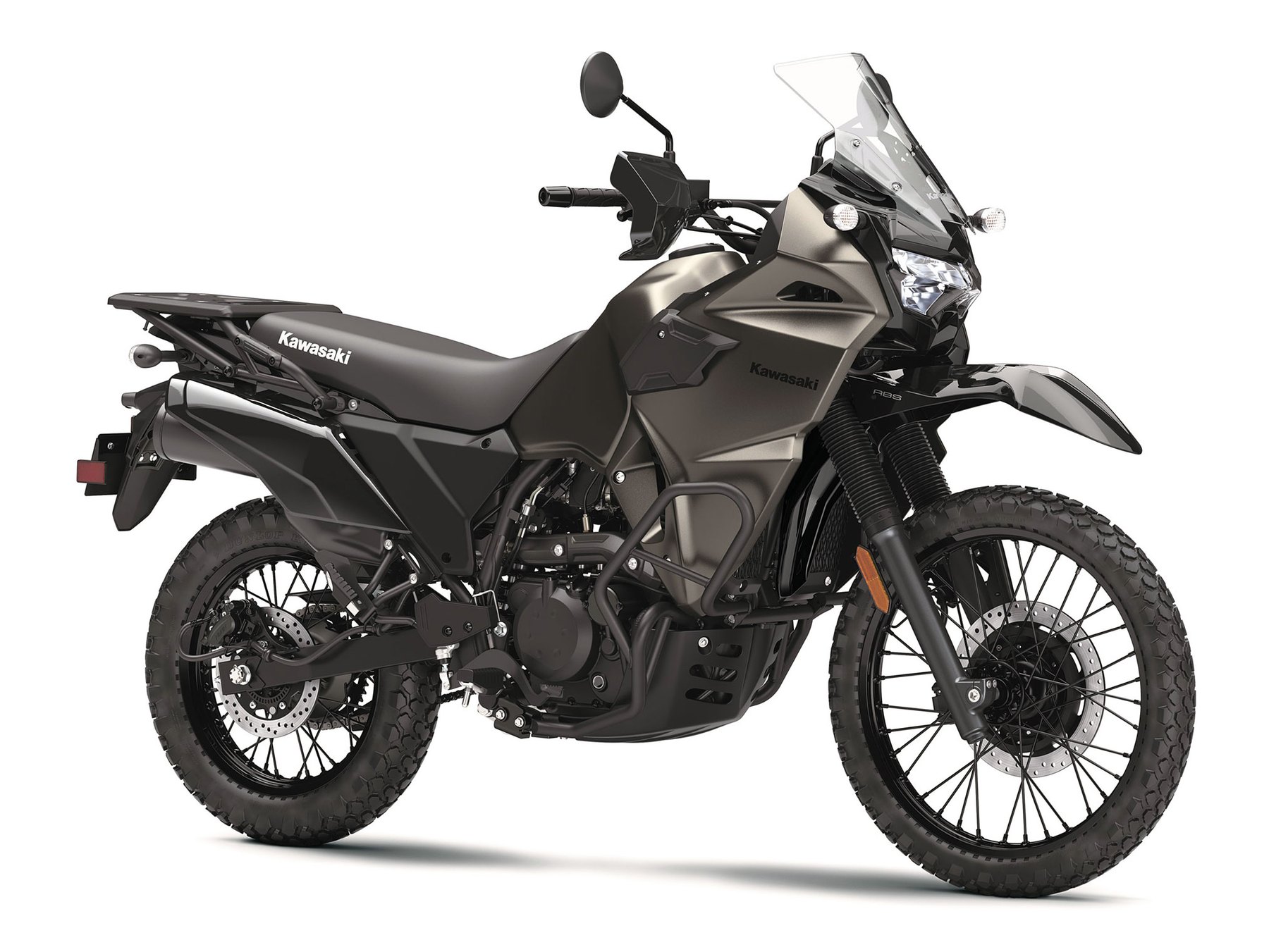 The DF in studio light. Everything that distinguishes it is visible here: the dark earth-tone bodywork, the tubular frame sliders wrapping the engine, the aluminium rear carrier, and the blacked-out fasteners, caliper bracket and suspension linkage.