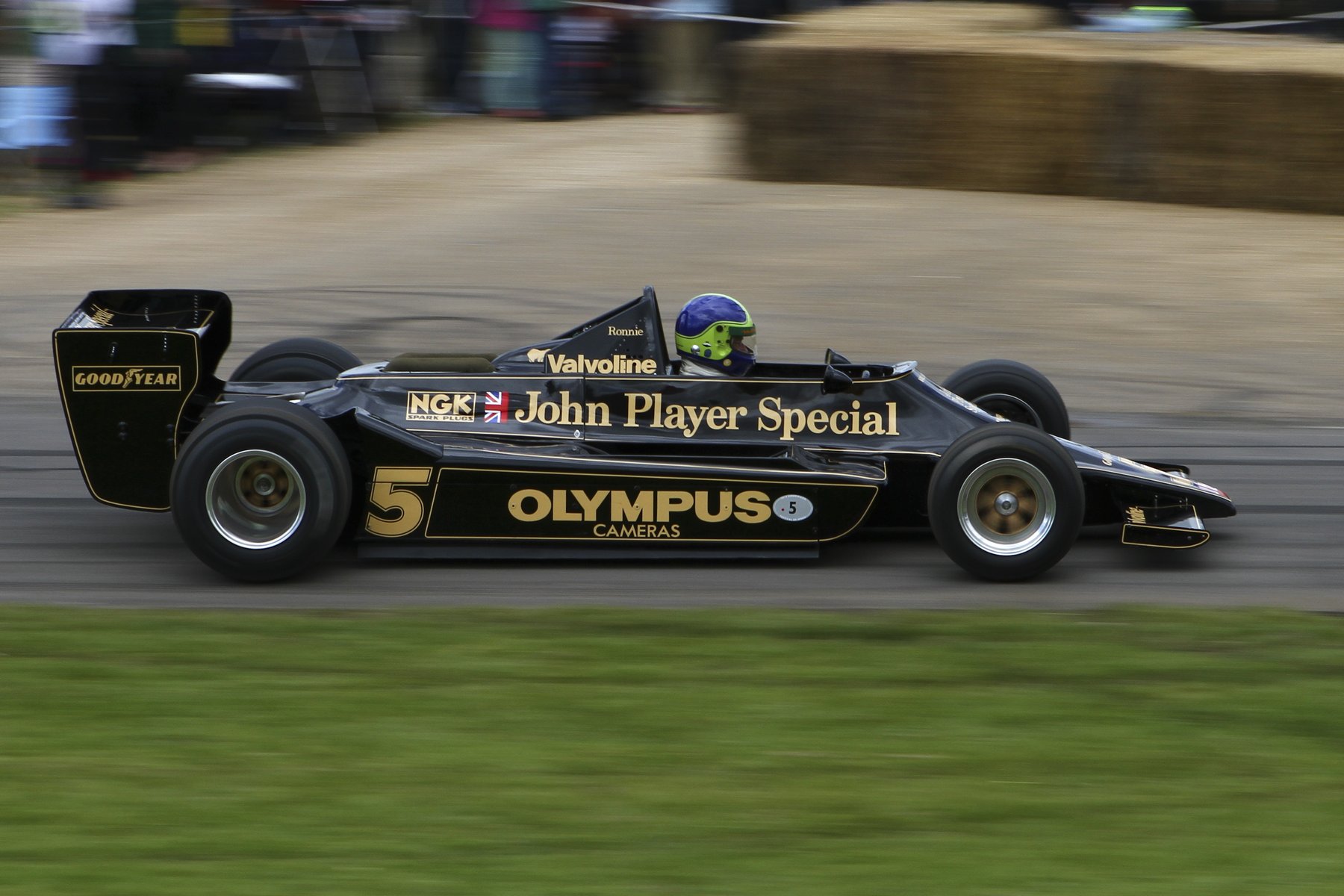 The Lotus 79 at the 2012 Goodwood Festival of Speed. The deep, full-length sidepods either side of the cockpit aren't bodywork for its own sake — they house the inverted-wing venturi tunnels that made this the first car to exploit ground effect properly, which is why the 79 could run a comparatively modest rear wing and still out-corner everything.
