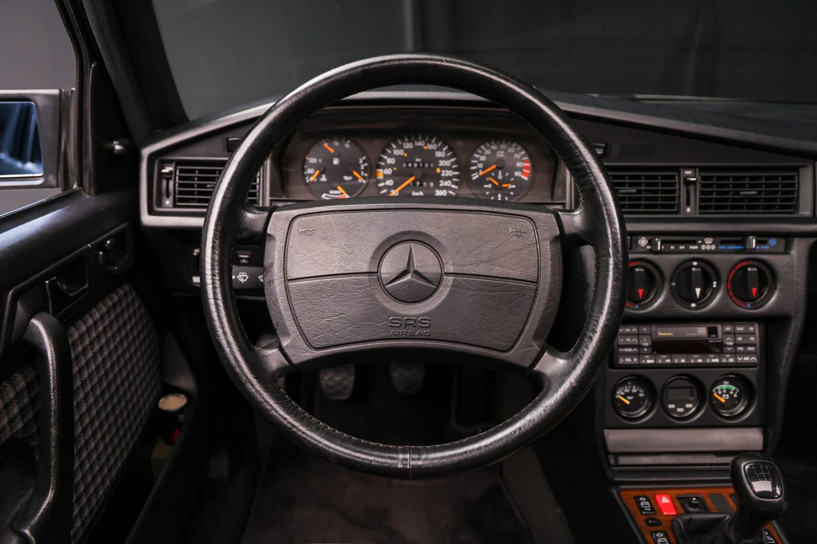A 260-km/h speedometer reading just under 49,000 kilometers, with oil temperature and voltage gauges added low in the center stack.