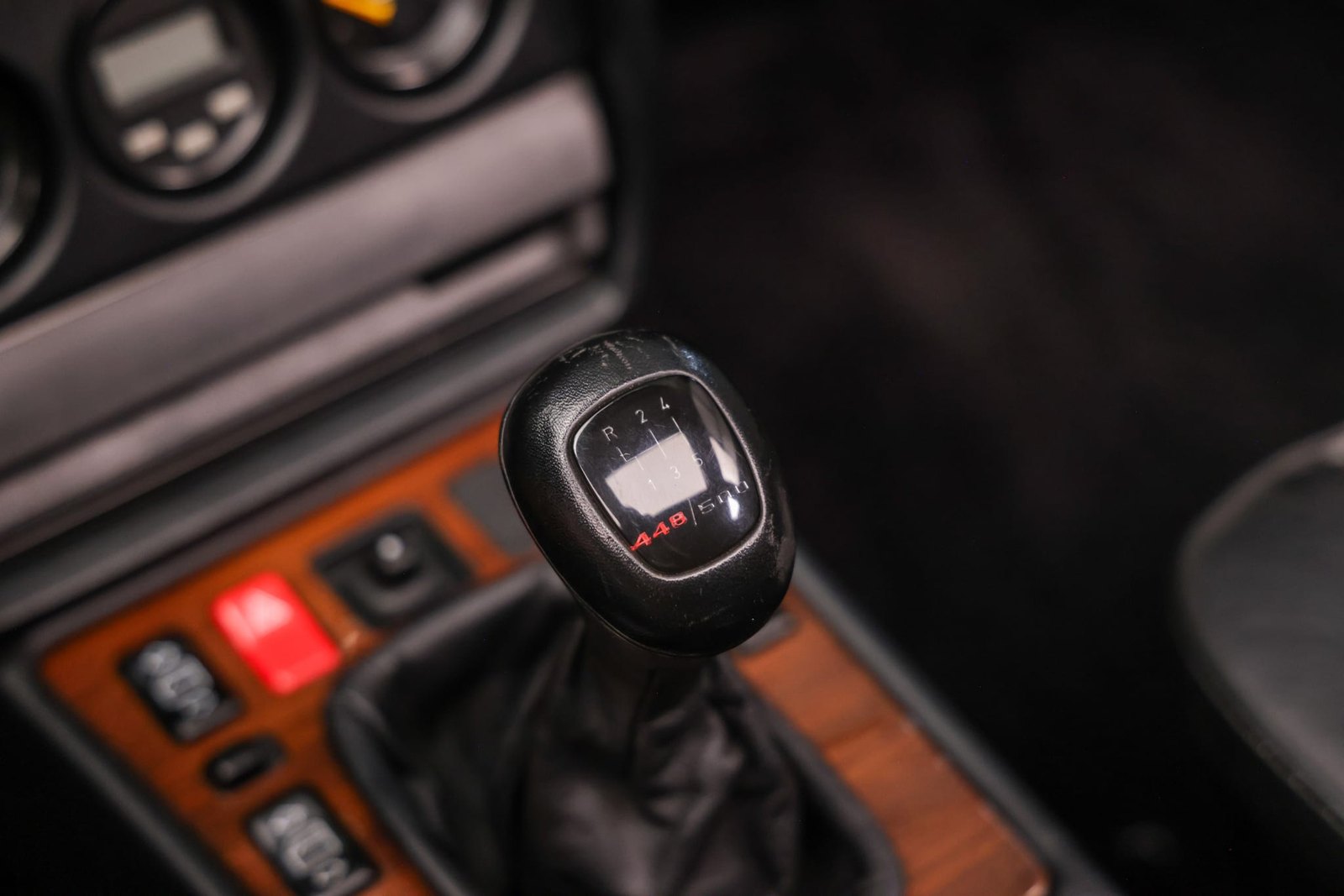 The shift knob plaque: build number 448 over 500, above the dogleg gate that puts first down and to the left.