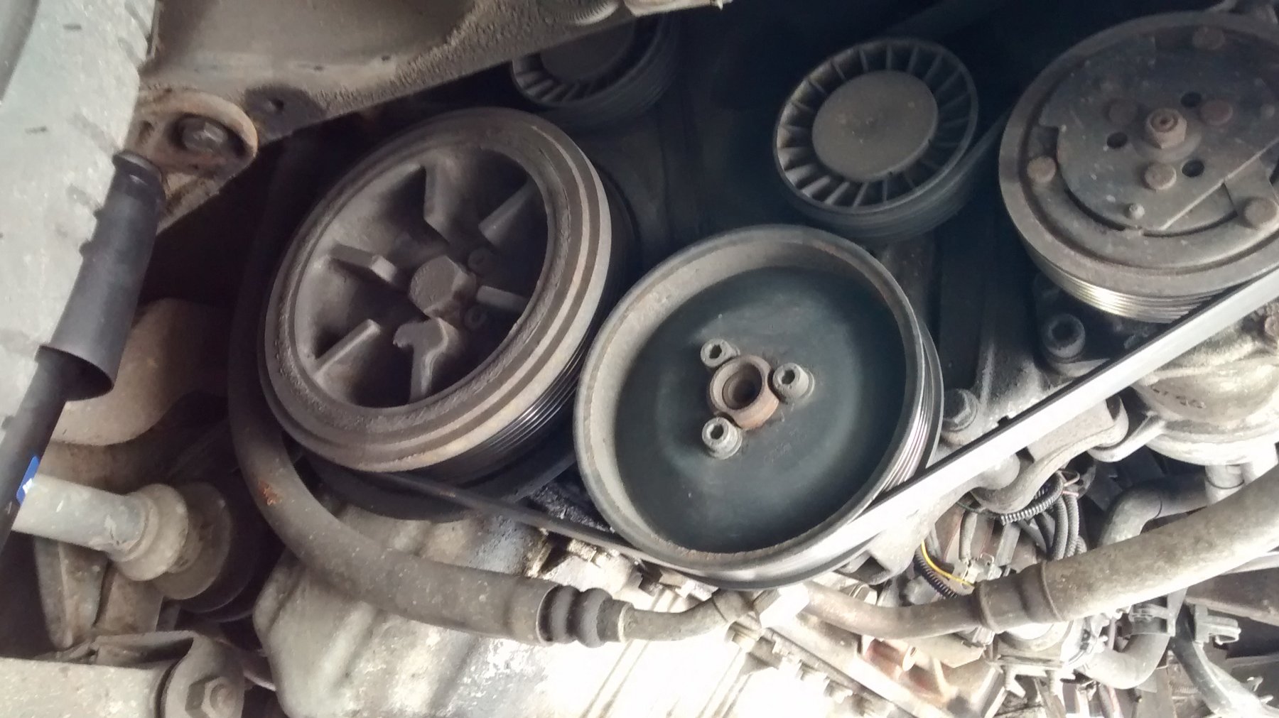 The accessory belt drive on a VW T4, with the power-steering pump pulley sitting in the middle of the run. Whenever the crank turns, that pump turns with it.