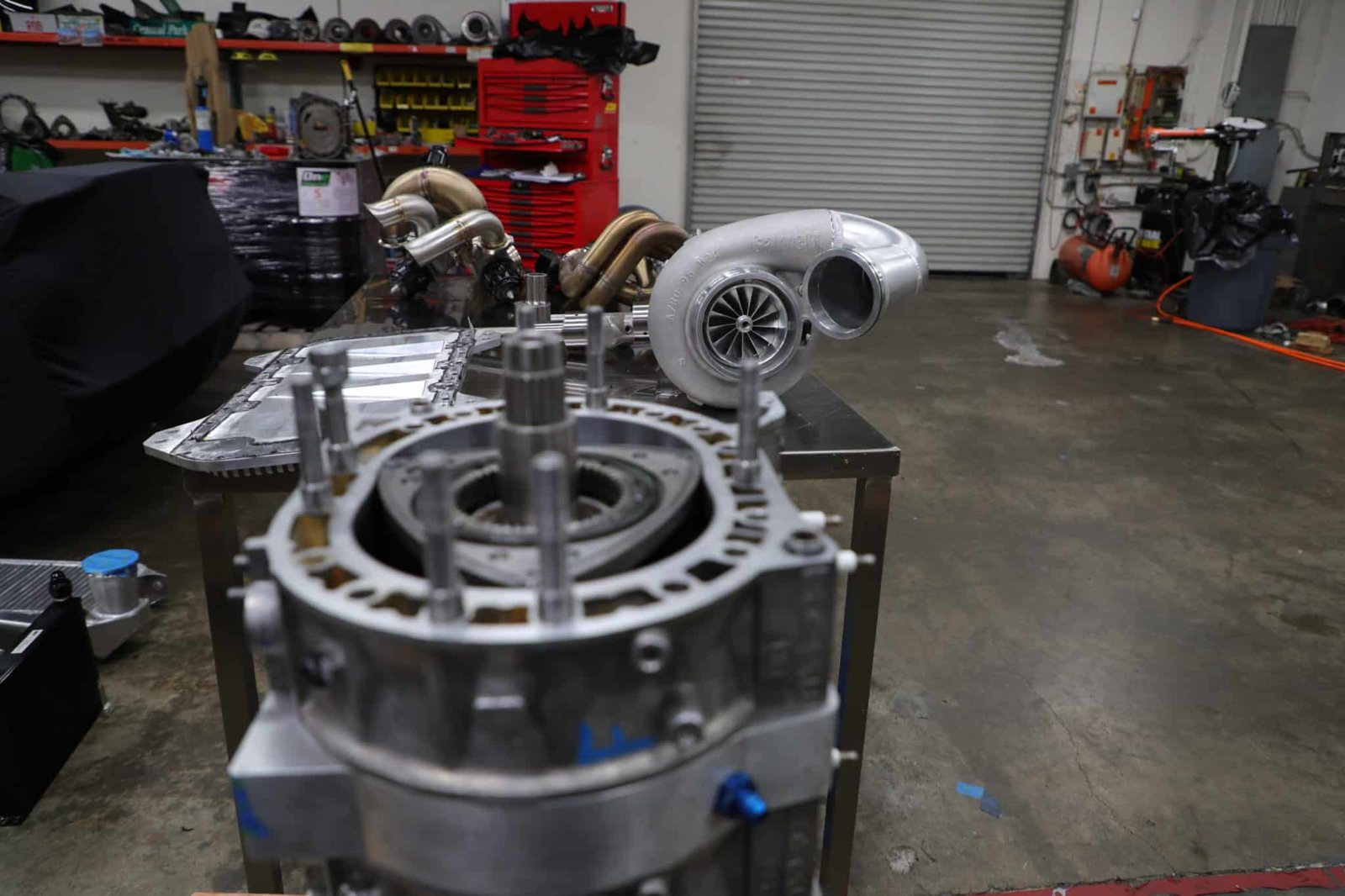The billet 4-rotor block on the bench, paired with the Garrett turbo that helped push the build past 1,000 rear-wheel horsepower.