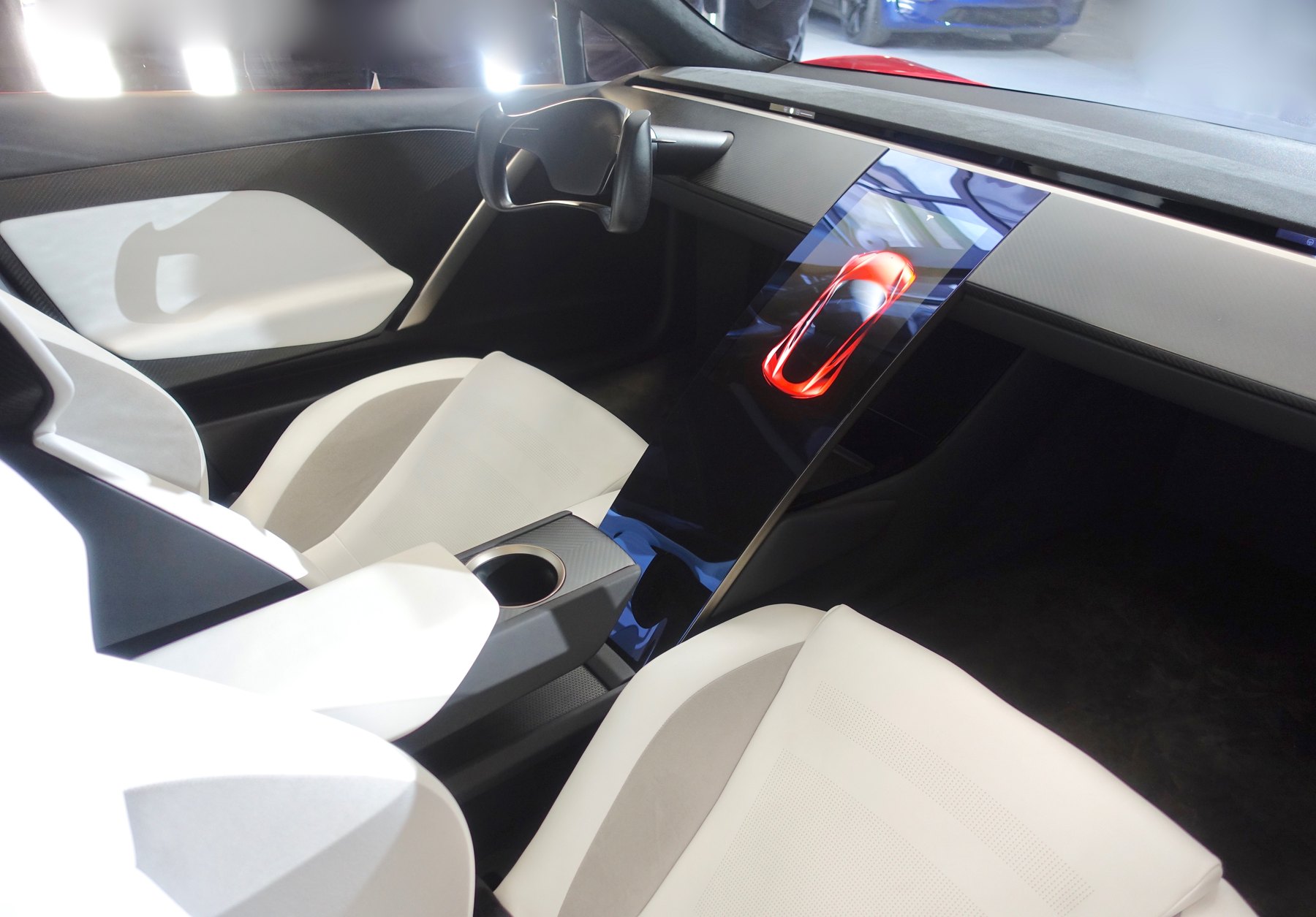The 2017 prototype's cabin, also shot in April 2019 — and a useful record of what has since been deleted. Those two rear seats are gone: the 2026 car is a strict two-seater, and the top Rocket trim seats one.
