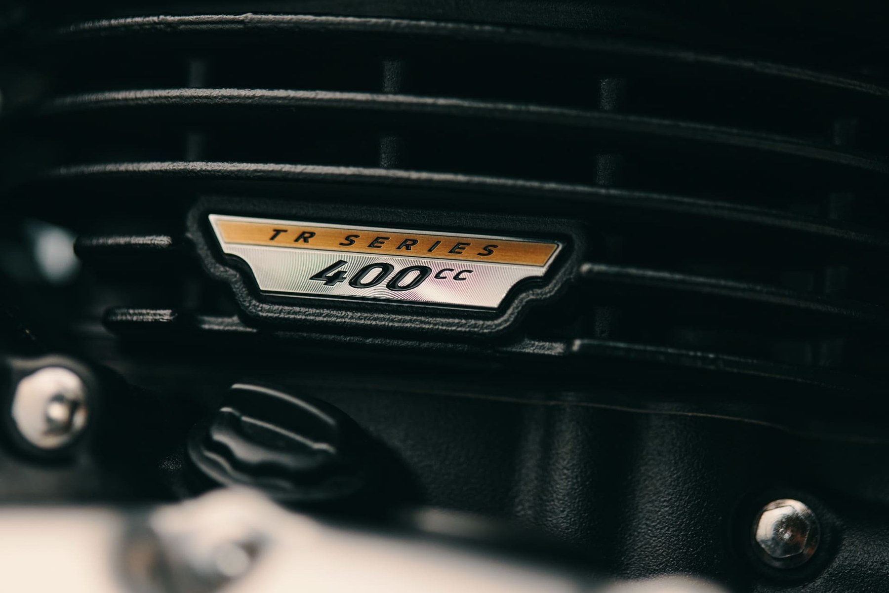 The badge on the global-market bike reads "TR SERIES 400cc" — the engine family name, not the displacement of every T40 sold under it. Triumph's British spec sheet lists 398 cc; its Indian spec sheet lists 350 cc.